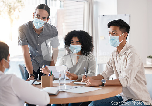 Image of Covid, business meeting and discussion with team listening to manager, mentor or boss while wearing face mask at boardroom table. Professional people sharing ideas, vision and mission strategy