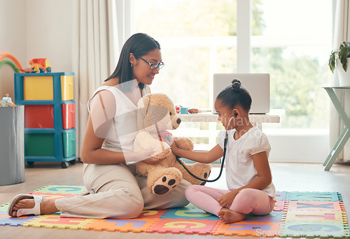 Image of Kindergarten, education and stethoscope with teacher and girl playing doctor game with teddy bear for development, learning and care. Classroom, wellness and therapist with young student and woman