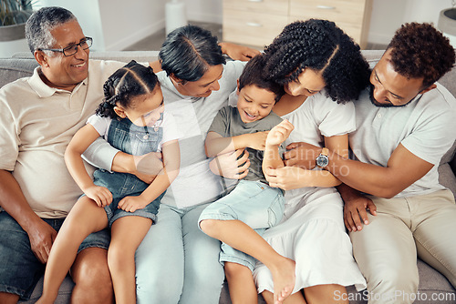 Image of Big family, bonding fun and love of children, parents and grandparents while sitting together on the sofa at home. Happy, laughing and tickling while sharing a special moment with men, women and kids