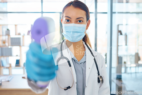 Image of Covid compliance, medical doctor and woman with face mask and thermometer check for safety and protection before entry in a hospital. Portrait of healthcare worker treating coronavirus