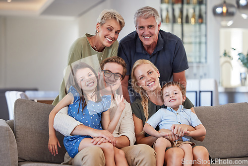 Image of Big family, love and smile of children, parents and grandparent sharing a bond and support while sitting on sofa at home. Portrait, happiness and multi generation men and woman spending time together