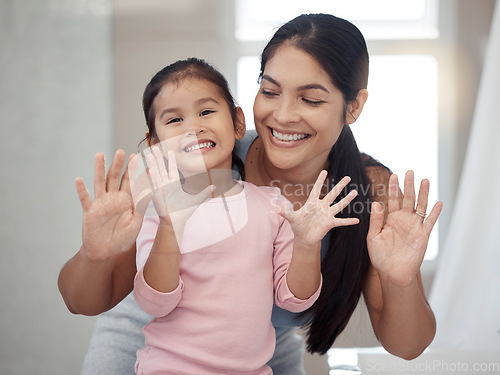 Image of Cleaning, hand and washing with mother and daughter bonding in a bathroom at home, smiling and relaxing together. Hygiene, protection and portrait of a girl feeling happy after learning healthy habit