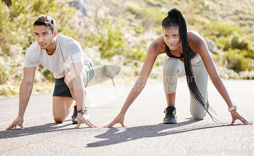 Image of Sports race, fitness couple and ready to run asphalt road with competitive, fit and active runners for outdoor workout. Asian man and black woman sitting in position to start sprint, athlete training