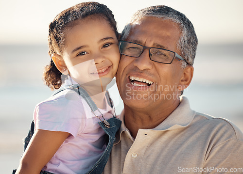 Image of Love, family and portrait of grandfather and child happy, bonding and enjoy fun quality time by the beach. Smile, happiness and face of kid girl with elderly grandparent or senior man relax together