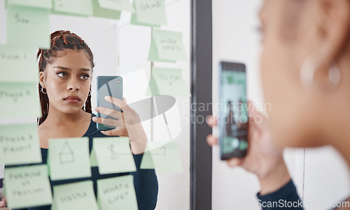 Image of Sad, anxiety and woman at mirror with phone for pensive reflection photograph for social media. Depressed black girl with frustrated and unhappy face thinking of self esteem problem in distress.