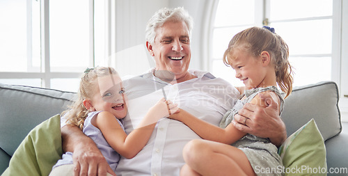 Image of Happy family, retirement and old man playing with children on the sofa bonding, happiness and laughing together. Smile, elderly and grandpa with little girls enjoying quality time on a couch at home