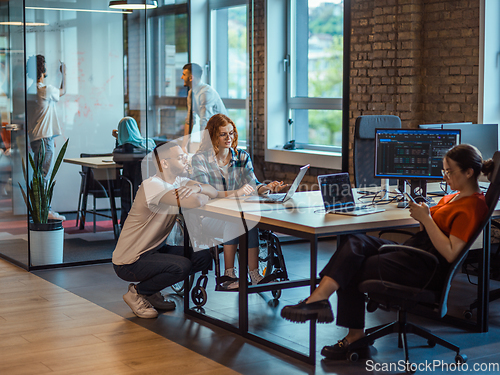 Image of A diverse group of young business individuals congregates in a modern startup coworking center, embodying collaborative innovation and a dynamic atmosphere