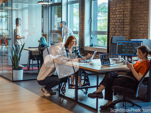 Image of A diverse group of young business individuals congregates in a modern startup coworking center, embodying collaborative innovation and a dynamic atmosphere