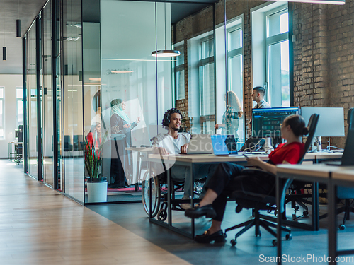 Image of A diverse group of young business individuals congregates in a modern startup coworking center, embodying collaborative innovation and a dynamic atmosphere