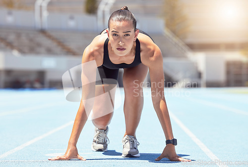 Image of Woman runner start position on race track, competition or cardio for healthy exercise, workout and fitness in stadium. Focus young female sports athlete ready in running challenge, speed and marathon