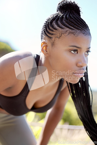 Image of Motivation, focus and fitness black woman about to run a sport workout outdoor. Sports training, health exercise and athlete with a serious face expression about to start a strong cardio session