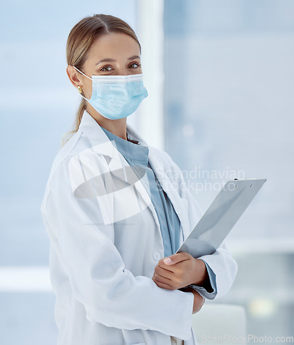 Image of Covid, woman doctor and face mask safety, medicine and risk in medical hospital, surgery and clinic. Portrait of corona virus clipboard research, healthcare expert and professional wellness therapist