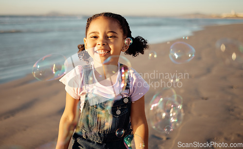 Image of Beach, bubbles and a girl playing at sunset, having fun and enjoying an ocean trip. Freedom, energy and child running alone the sea, excited and playful while chasing bubble and laughing in nature