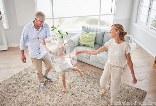 Image of Family or grandparents dancing with child in living room for wellness, healthy body movement and growth development in retirement lifestyle. Happy energy, grandmother and grandfather dance with kid