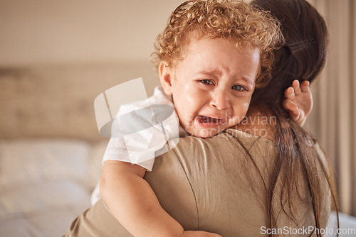 Image of Mother and crying baby in a bedroom with portrait of sad son looking upset at nap time. Children, love and insomnia with baby boy comfort by loving parent, embracing and bond in their home together