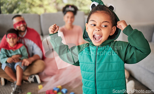 Image of Child, fun and dress up for Halloween with energetic, brave and strong girl playing dress up wearing costume with family at home. Energetic, playful and imagination of kid during pretend game