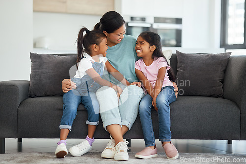 Image of Family, love and single mother with kids looking happy, relax and smiling sitting together and bonding on sofa in lounge at home. Asian babysitter woman hugging cute girls, daughters or twin sisters