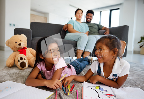 Image of Happy little children drawing with parents in the background at home living room. Kids enjoying quality time and creative art together while man and woman babysitting children in the living room