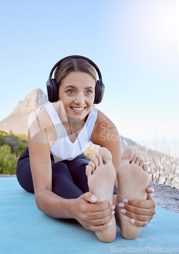 Image of Outdoor yoga, stretching and woman with headphones listening to wellness podcast or calm music for exercise motivation. Sports person in cardio or pilates workout with audio in nature and lens flare