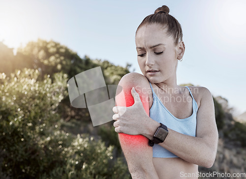 Image of Woman, fitness and arm injury, muscle tension or joint inflammation holding painful area in nature. Injured fit female in pain from training, workout or exercise accident touching sore arms in strain