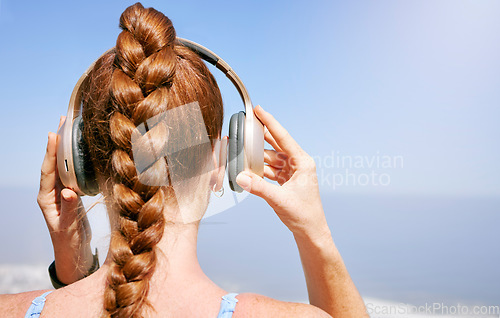 Image of Fitness, nature and woman listening to music during exercise, health and cardio workout with scenic views. Radio, podcast and streaming with rear view of female prepare for zen and relax meditation