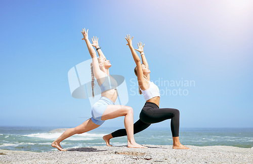 Image of Health, meditation and women doing yoga at beach, mediation and fitness training in summer together. Peace, energy and friends exercise and bond while stretching in the sun and enjoying the ocean