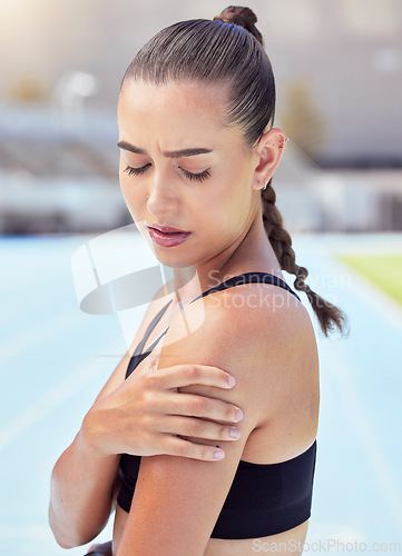 Image of Woman athlete hands shoulder pain, emergency health risk and muscle strain during workout, training and exercise. Closeup of female runner touching pulled muscle, arm injury and sore outside on track