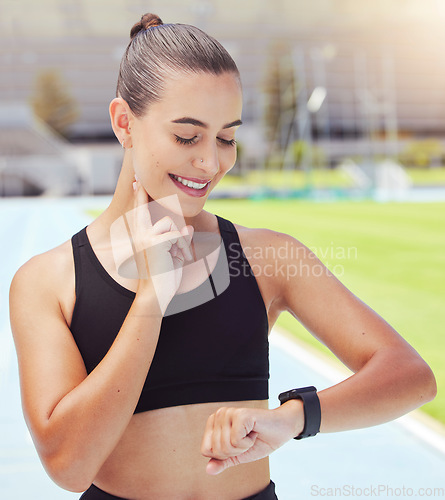 Image of Sport, watch and time with a sports woman training during a workout and checking or tracking her progress. Health, fitness and wellness with a young female athlete timing her performance on a run