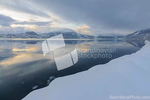 Image of Tranquil Winter Evening Overlooking a Calm Snow-Covered Fjord Wi