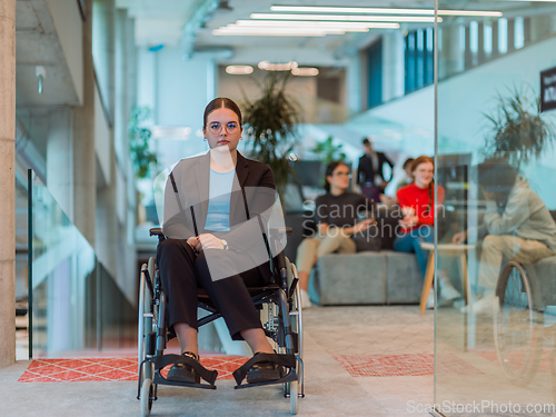 Image of In a modern office, a young businesswoman in a wheelchair is surrounded by her supportive colleagues, embodying the spirit of inclusivity and diversity in the workplace