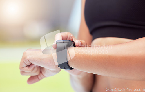 Image of Smartwatch on hands of runner to track woman running time, health stats and train for competition race. Smart watches help competitive performance, motivate and inspire athlete to improve record time