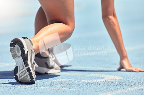 Image of Running, shoes and start with a sports woman or female runner on a track for a workout, exercise or training. Fitness, run and cardio with an athlete getting ready for a competition or race outside