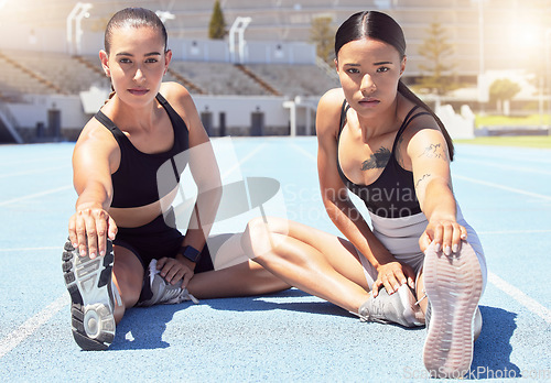 Image of Fitness, stadium and women stretching hamstring on racetrack ready to start training, exercise and cardio workout. Wellness, girls and portrait of healthy runners at a sports competition in summer