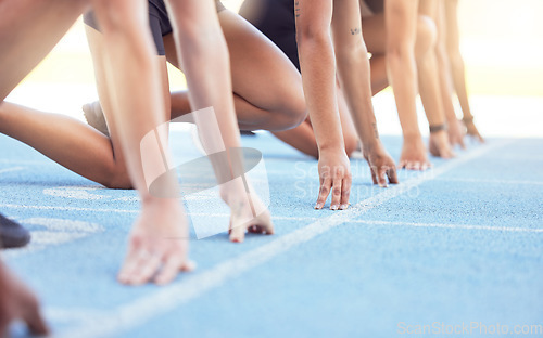 Image of Runners with hands on start line on the track for a race, ready to run. Racing challenge or sprint at sports event with closeup for motivation, concentrate and focus in athletes running on track