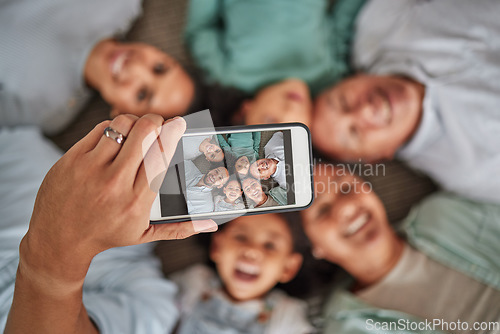 Image of Family selfie, phone face and hand of man with technology with grandparents and children, smile while relax and happy on living room floor. Parents, kids and elderly people taking photo on tech