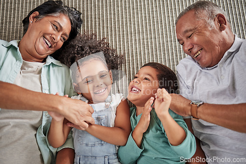 Image of Happy family, grandparents and children on a sofa, relax and laughing while bonding in e living room together. Love, laugh and happy kids playing, enjoy time and fun game with elderly man and woman