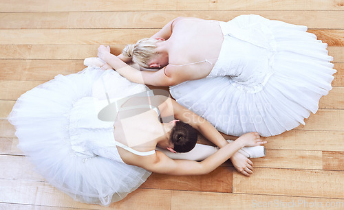 Image of Ballet women, theatre concert and dance stage for creative training, performance and professional dancers. Above of two girl ballerinas stretching dancing and start music show action on studio floor