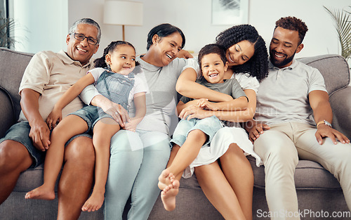 Image of Love, children with grandparents in a big family as mother and father hugging kids on the sofa or couch. Dad mom and young children happy to enjoy bonding with lovely grandmother and old man at home