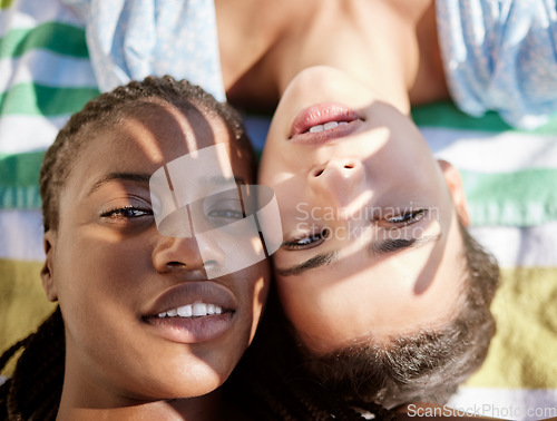 Image of Summer, selfie and a girl and girlfriend at the beach lying on a towel, shadow of hands in face. Pride, lgbt and young woman best friends or lesbian couple relax in sun by the ocean on the weekend.