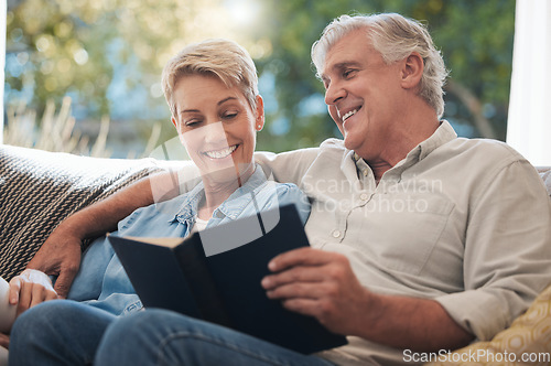 Image of Senior, pension and reading couple with a happy smile at home on a lounge sofa. Love, calm and happiness mindset of a elderly couple with books together looking at pages of a book on a house couch