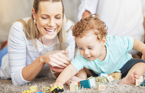 Image of Mother, kid and play learning block toys on floor for educational bonding time together in family home. Young, caring and loving woman helping toddler with child development and coordination skills.