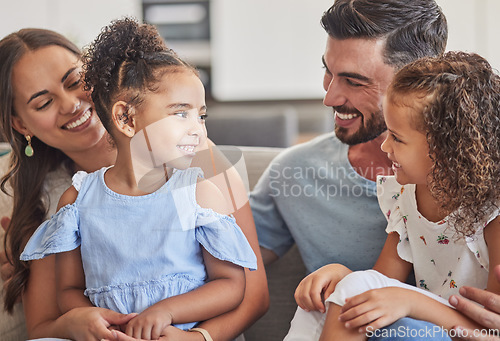 Image of Family, smile and love of children for their mom and dad while sitting together in the lounge at home sharing a special bond. Happy interracial man, woman and girl kids hug their parents in Brazil