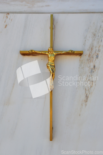 Image of golden crucifix on marble background