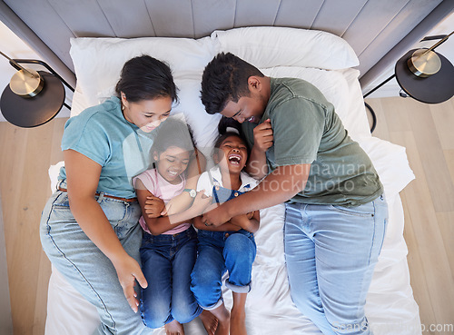 Image of Family bed, home relax and parents in bedroom with children, care for comic kids and love in house together from above. Top view of girl siblings laughing with happy mother and father in the morning