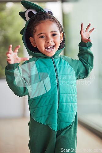 Image of Child, halloween and playing role in costume in a living room at home and having fun being creative. Happy girl kid as fantasy dinosaur in character, smiling and excited to roar and play game