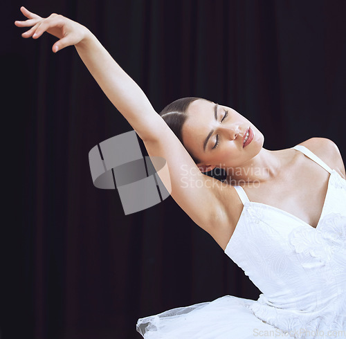 Image of Woman, dance or studio ballet on stage or theatre for performance routine, creative art motion or theater training. Stretching dancer, artist or ballerina student on black background in dancing class