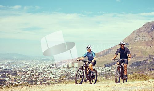 Image of Fitness, couple and cycling bicycle on a mountain hill or trail together in nature, training and cardio exercise outdoors. Lifestyle, sports and healthy woman cycling with athletic partner in summer