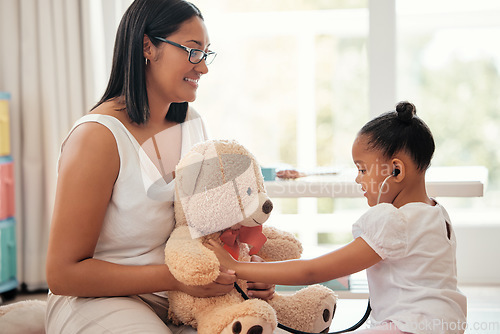 Image of Teddy bear doctor, girl game and mother with smile for child, happy medical work and family love for healthcare in home. Girl and mom giving support and help playing nurse to toys in house together