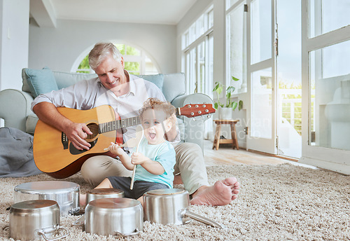 Image of Child drummer with grandfather, guitar and music playing with pot drums in the living room at house. Happy, excited and smile of boy bonding and spending time with his elderly grandpa in family home.