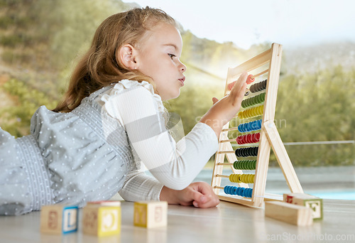 Image of Education, abacus and girl learning math with a color tool while counting on the floor. Young child or student play mathematics or calculate game with educational toy for academic knowledge in house